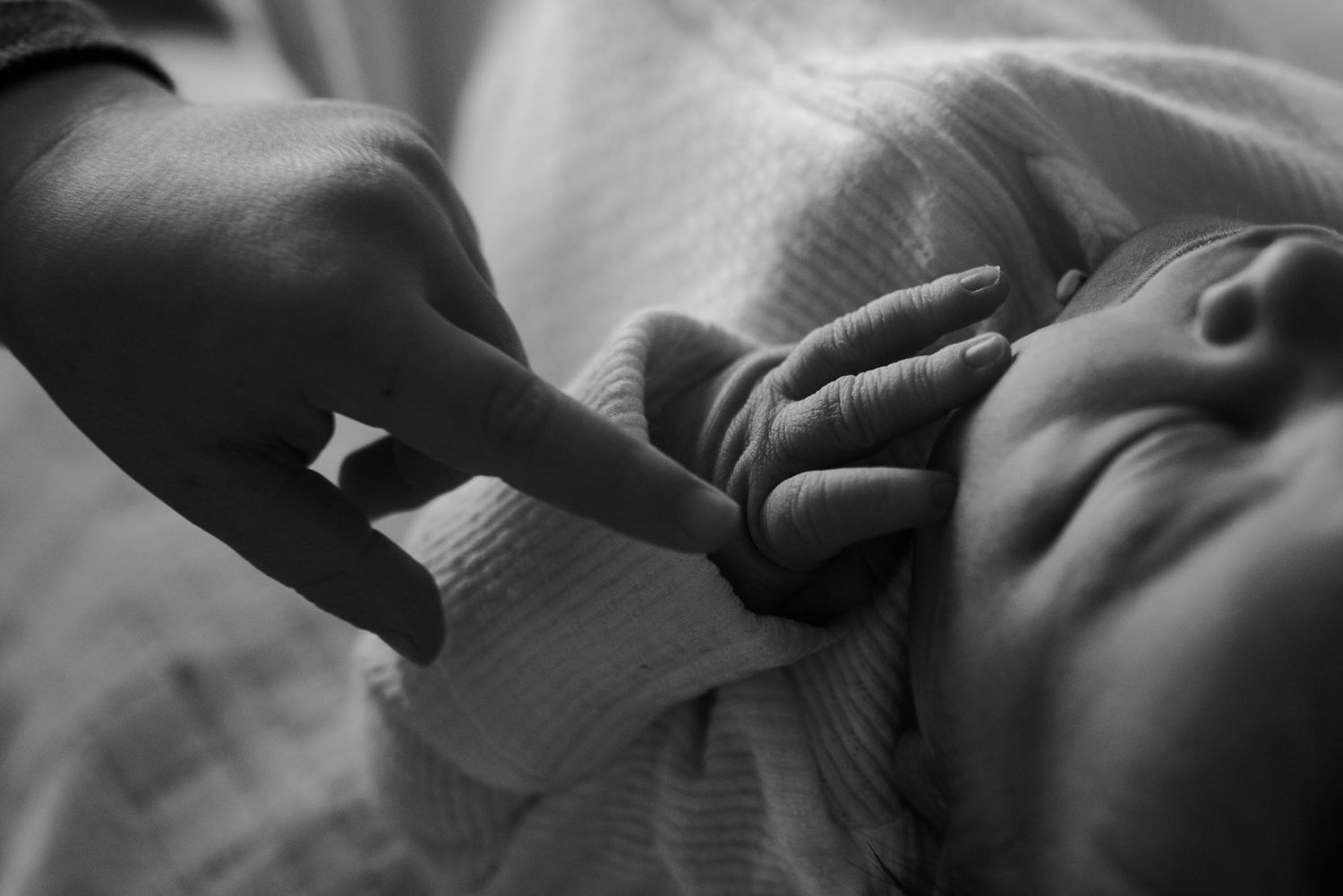 Black and white close-up photos showing hands in various gestures and positions against a dark background.