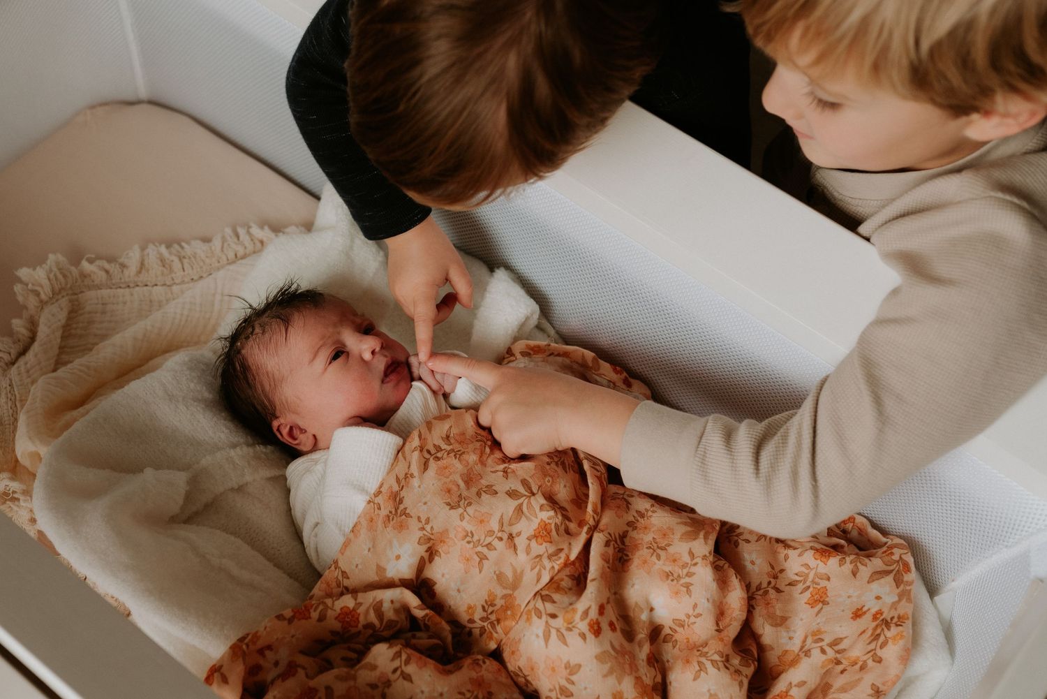 Parent and child share an intimate bonding moment while bottle feeding in a warm, natural light setting.