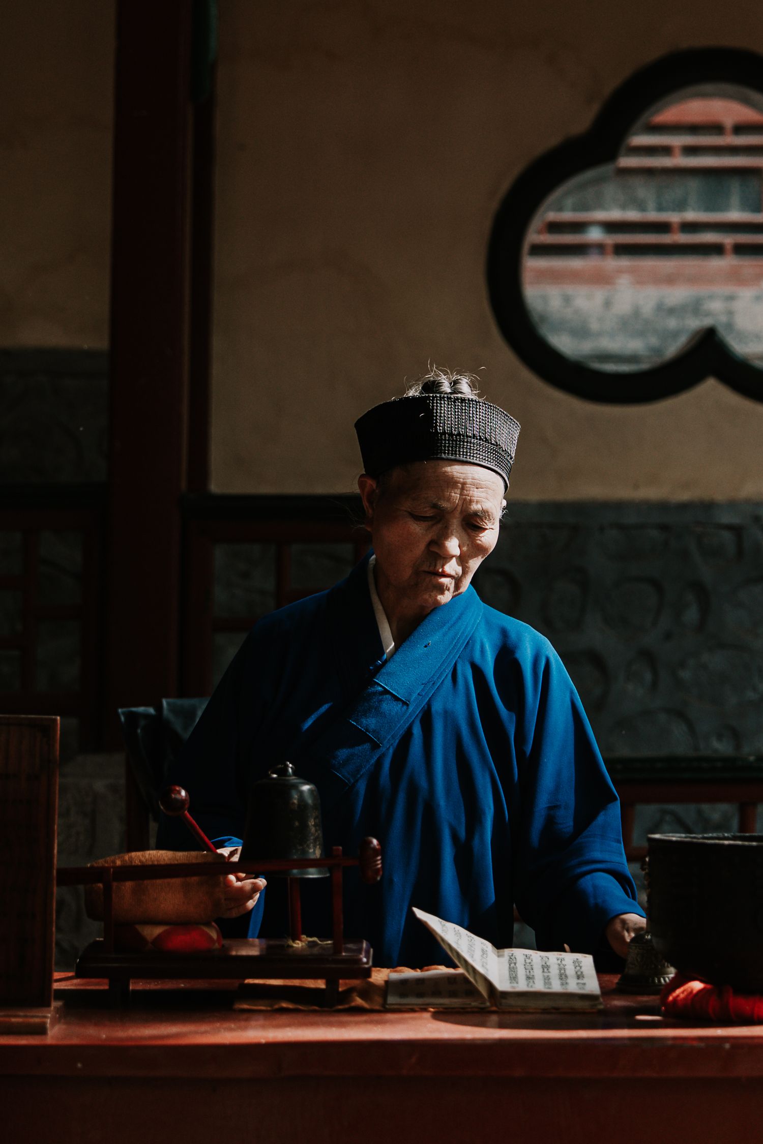Chinese monk doing a ceremony in a temple