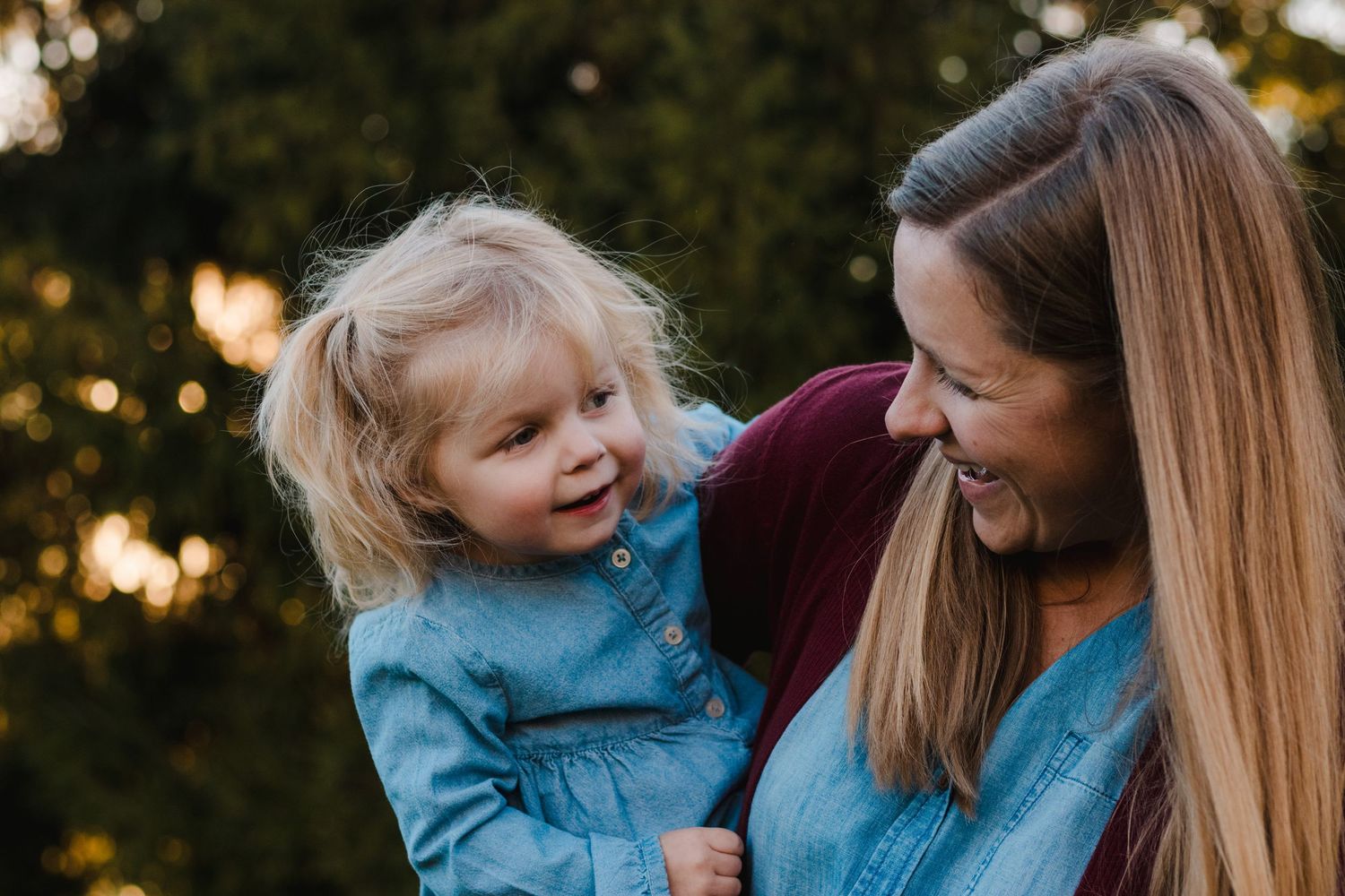 Mother and daughter smiling during lifestyle family photo session in South Lyon, MI.