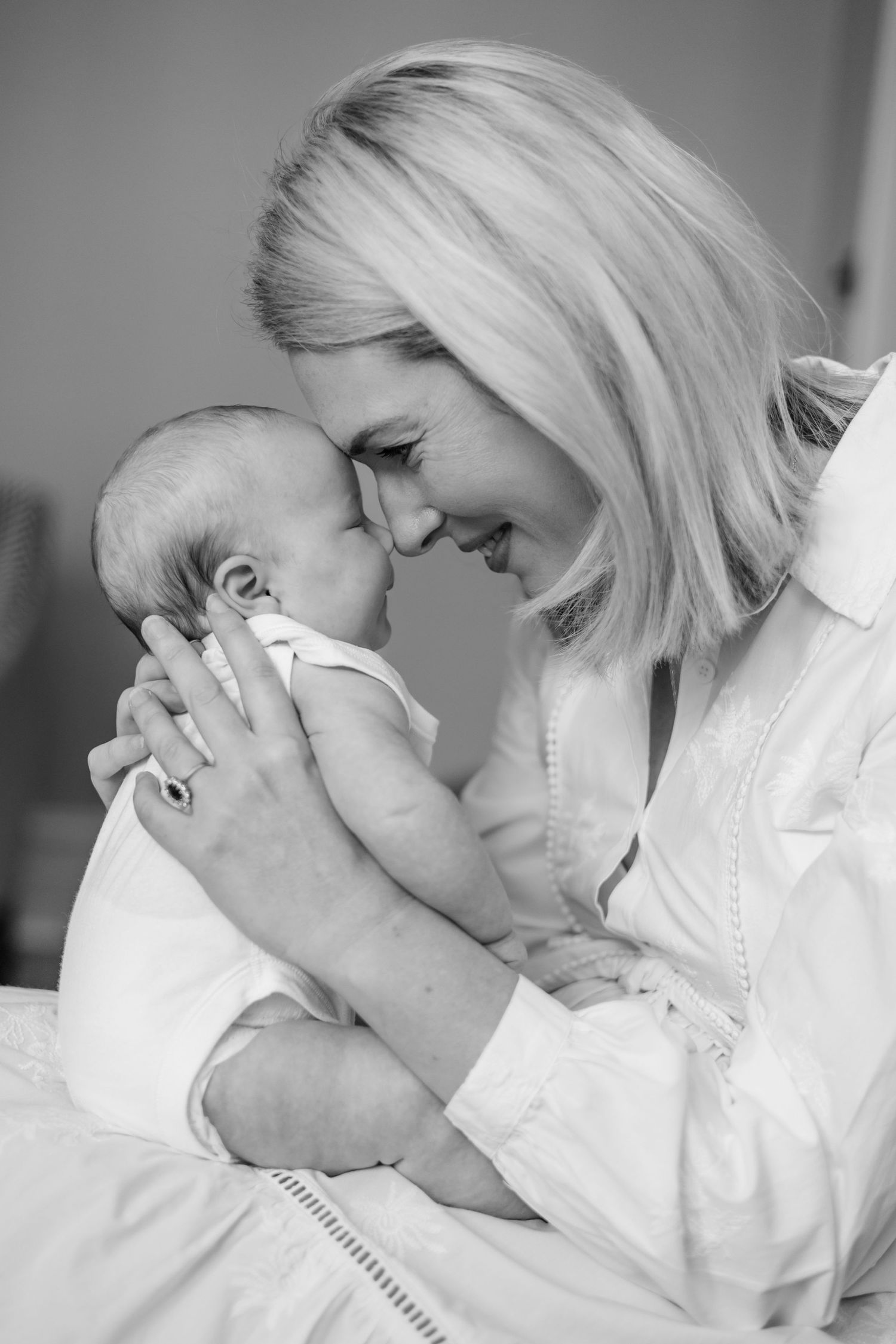 A timeless image of a mother and baby touching foreheads in a sweet moment, captured in black and white in Balham, London