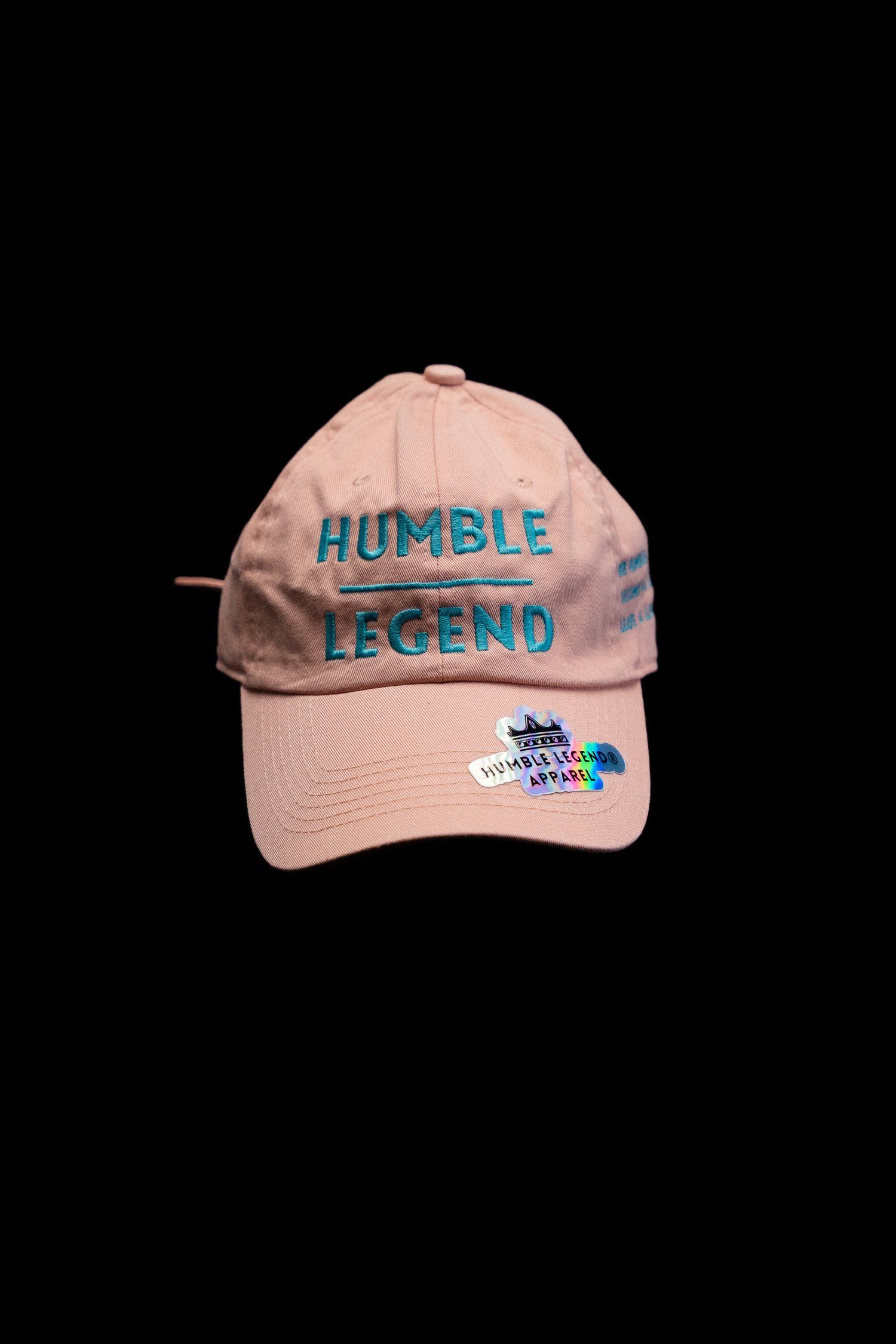 Pink baseball cap with 'Humble Legend' text embroidered in blue on the front.