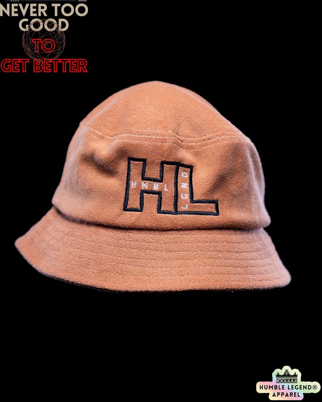 Tan bucket hat with 'HL' logo and 'Never Too Good to Get Better' text on black background.