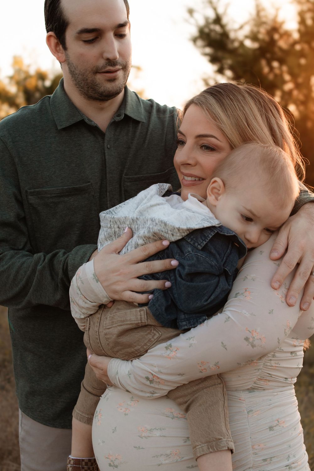 A sweet family embrace captured during golden hour outdoors.