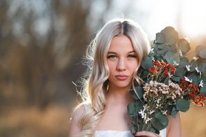 A collection of soft focus portrait photos with autumn foliage and eucalyptus bouquets in golden afternoon light. Senior portraits by Dusty