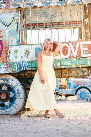 A series of artistic portraits taken in an urban graffiti setting featuring yellow dress and rustic elements. Slab City, Salvation Mountain.