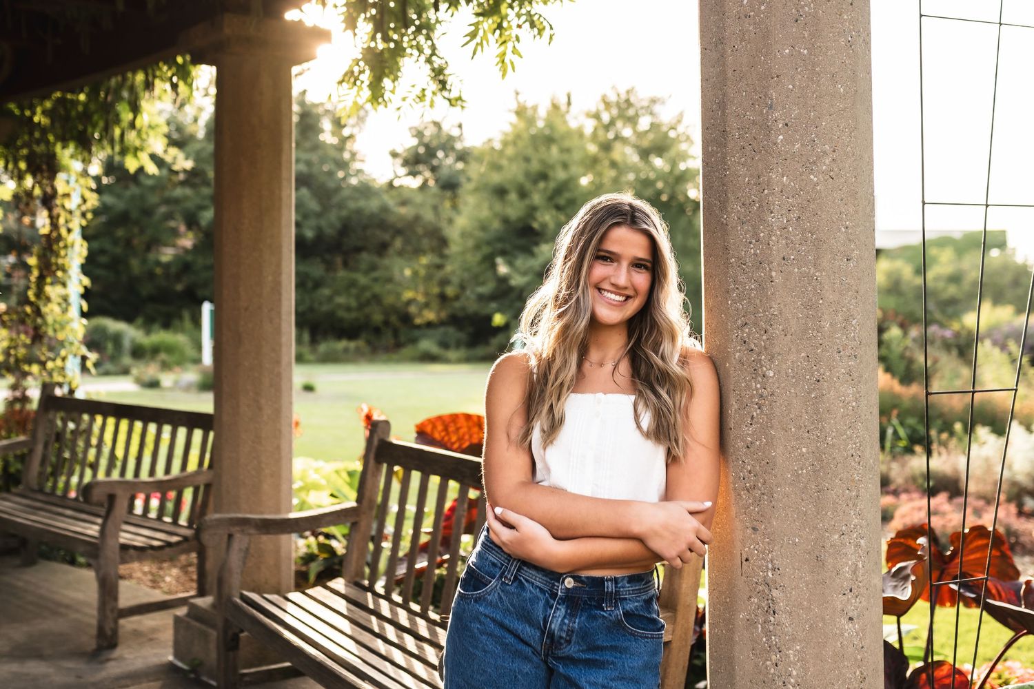Senior portrait of a girl laying on the football field in her cheerleading uniform.
