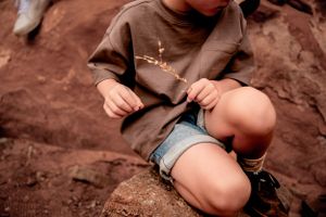 close up of son's hands playing with a flower in Canonlands Moab, Utah