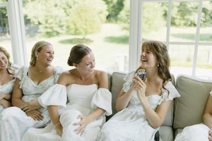 A collection of candid wedding photos showing intimate moments between a bride and groom sitting together on white furniture.