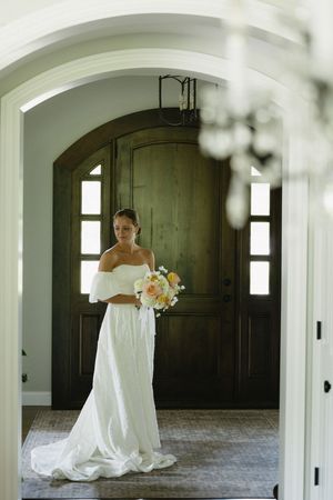 A series of panoramic bridal portraits taken in an elegant arched hallway with wooden doors and natural lighting.