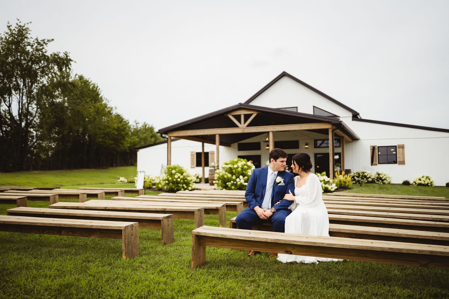 A series of outdoor wedding venue photos showing wooden benches, ceremony seating, and rural landscapes.