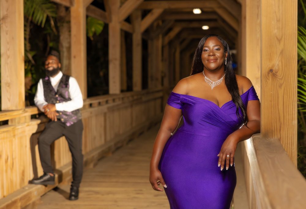 Romantic photoshoot in rustic covered walkway with elegant purple gown.