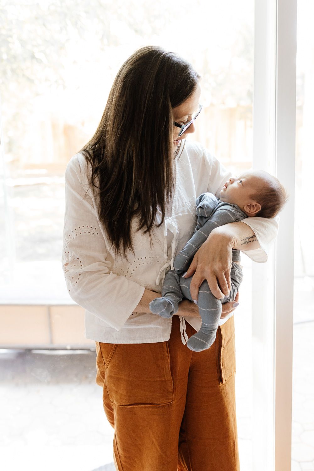 A grandma holds her new grand baby during his Bay Area newborn photo session