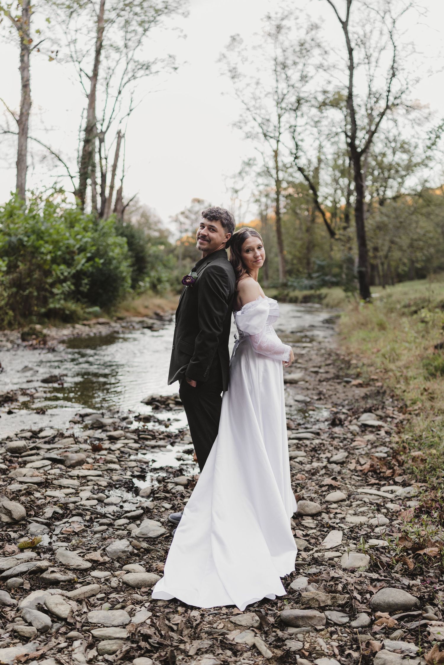 Bride and groom photographed along a scenic creek during their Smoky Mountains wedding