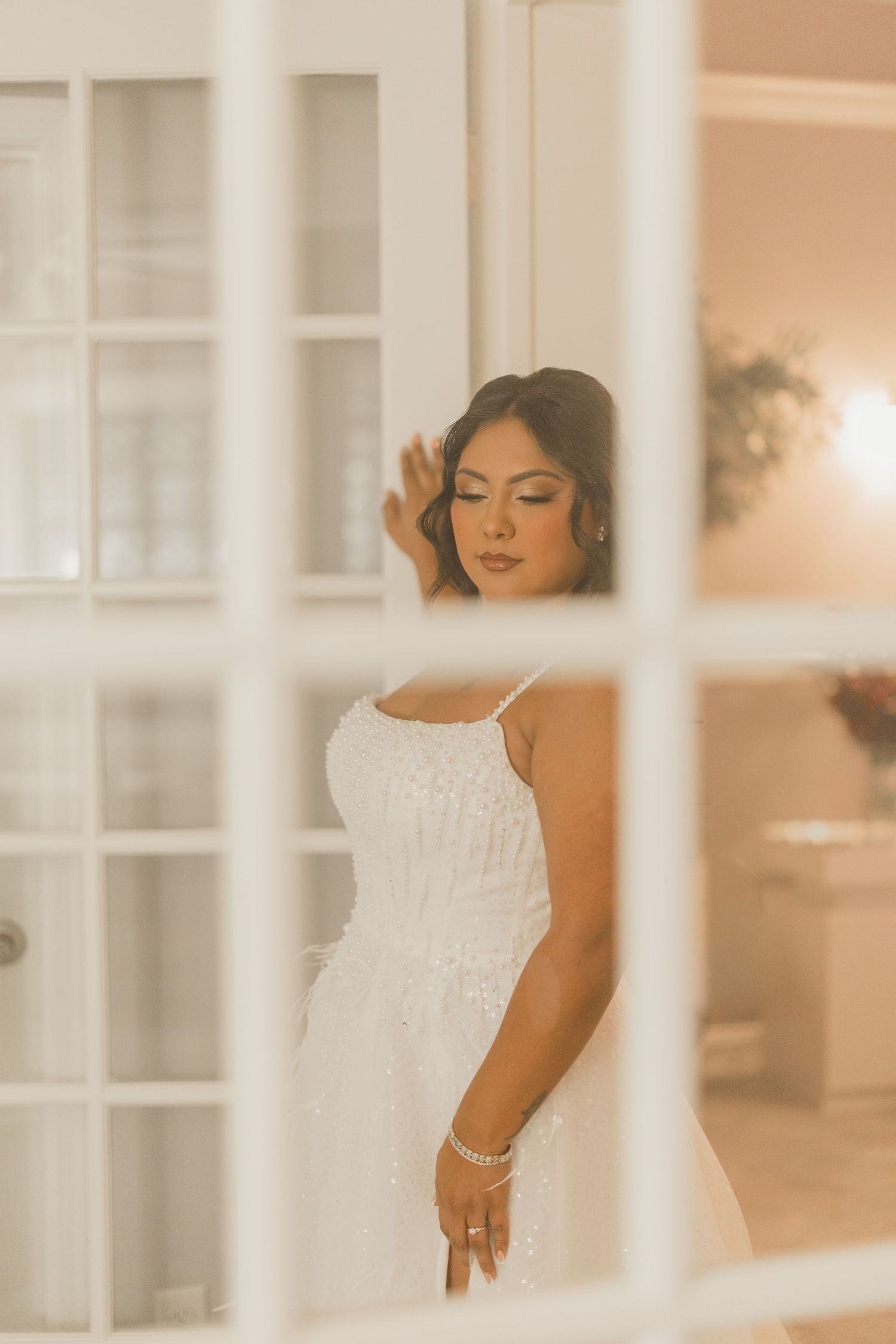 Editorial bridal portrait photographed through a window at The Starlight Garden in Spring, Texas.