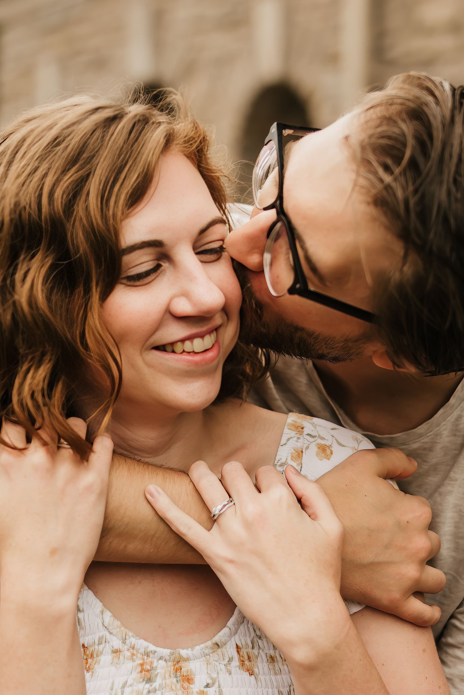 Husband kisses wife on her cheek during their cincinnati photo session.