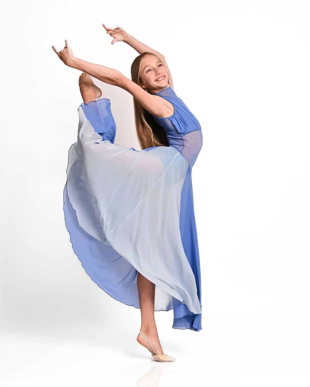 Dancer in flowing blue and white dress performs graceful contemporary dance movement sequence.