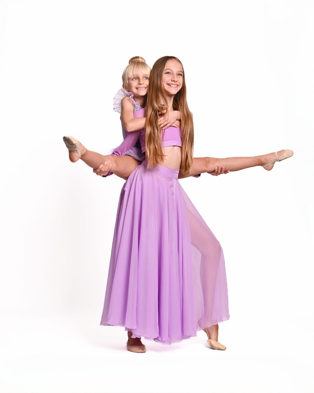 A dancer in a flowing purple dress performs graceful ballet poses in a sequence of movements against a white background.