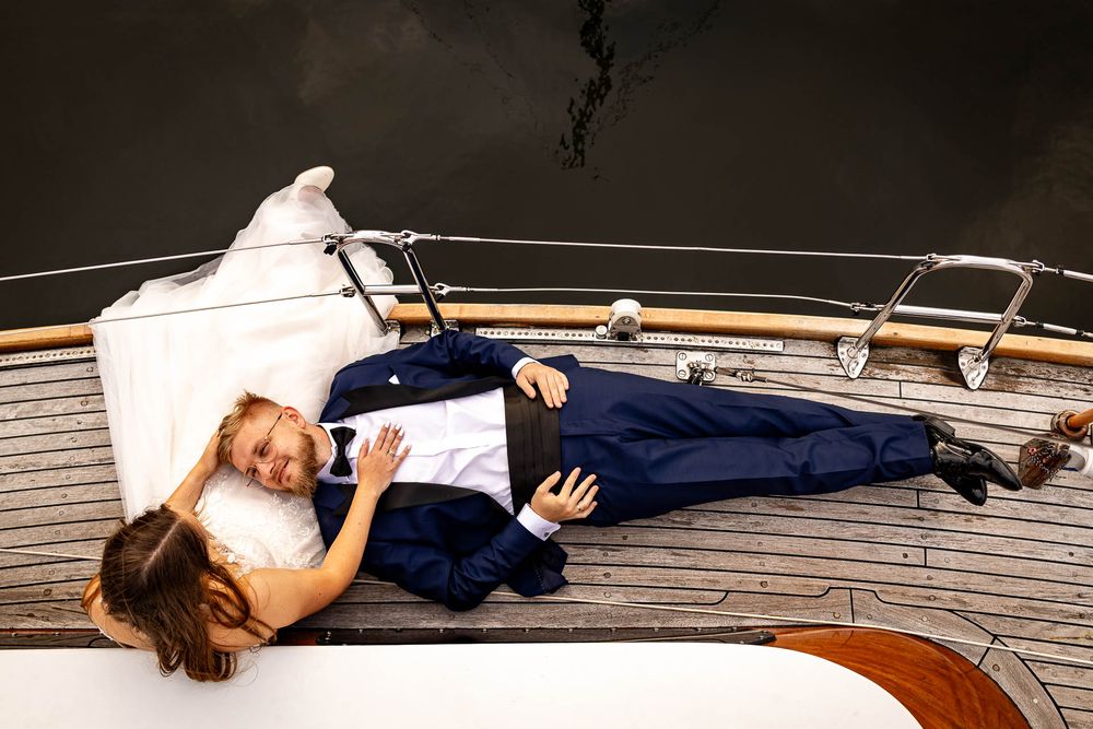 Artistic wedding photography sequence showing couple posing on a dock.