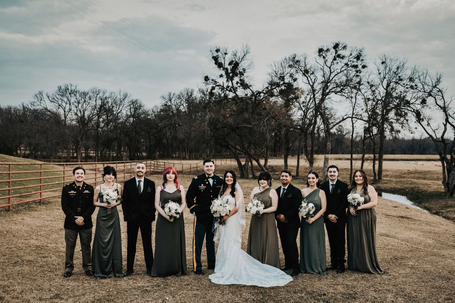 Wedding party celebrating with raised bouquets and hands in the air for a fun editorial moment.