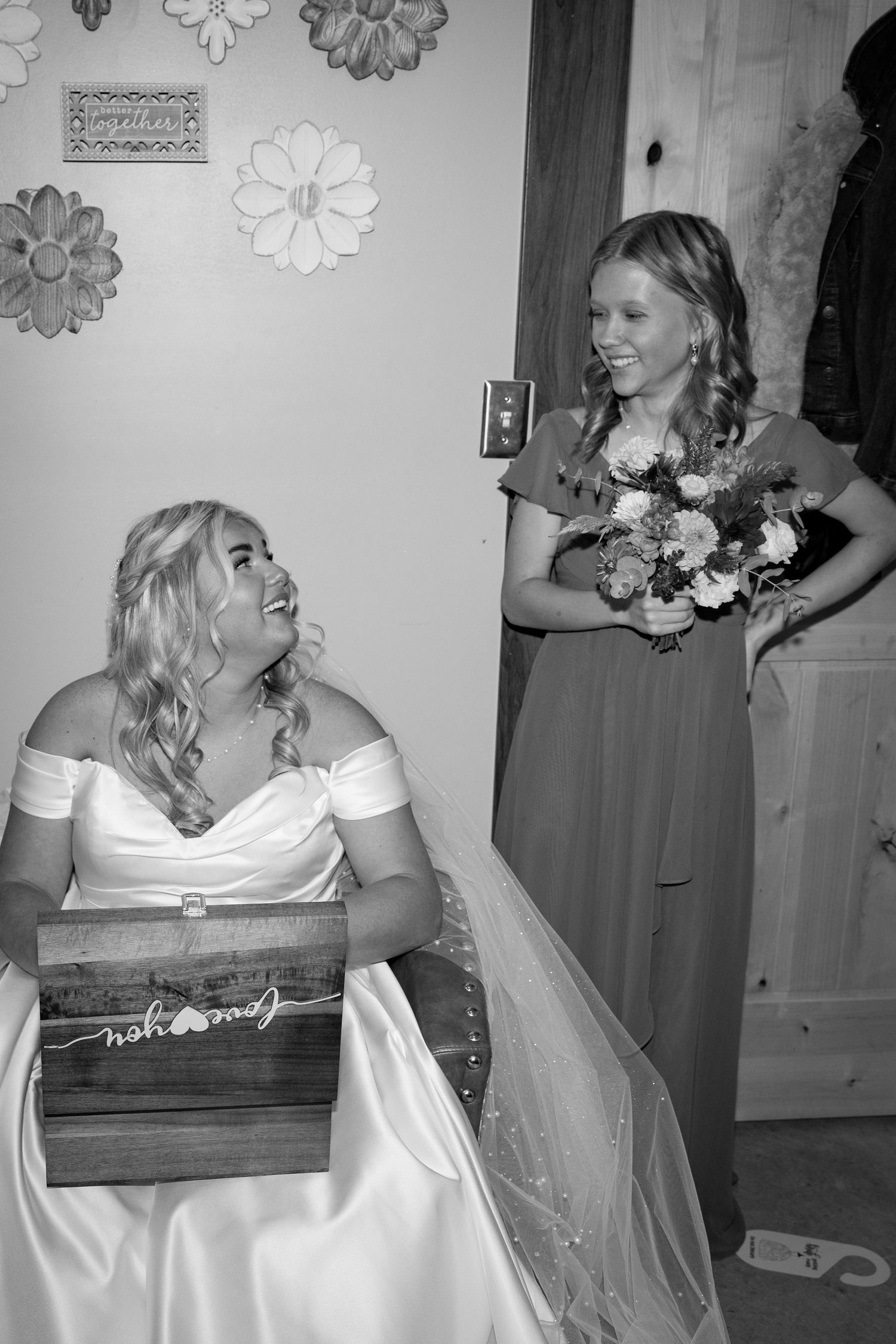 A series of black and white photos showing someone in a white wedding dress getting ready for their special day.
