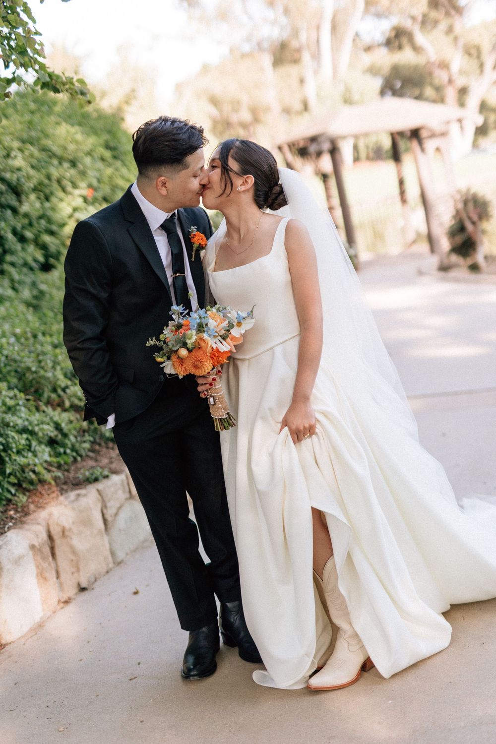 Authentic Santa Barbara wedding photographer film shot of the couple walking through the paths at Alice Keck Memorial Gardens during sunset.