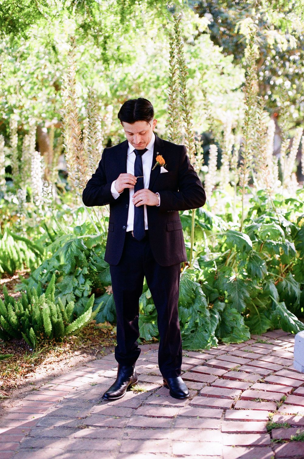 Santa Barbara film photographer captures a groom in a black suit in Santa Barbara on his wedding day.