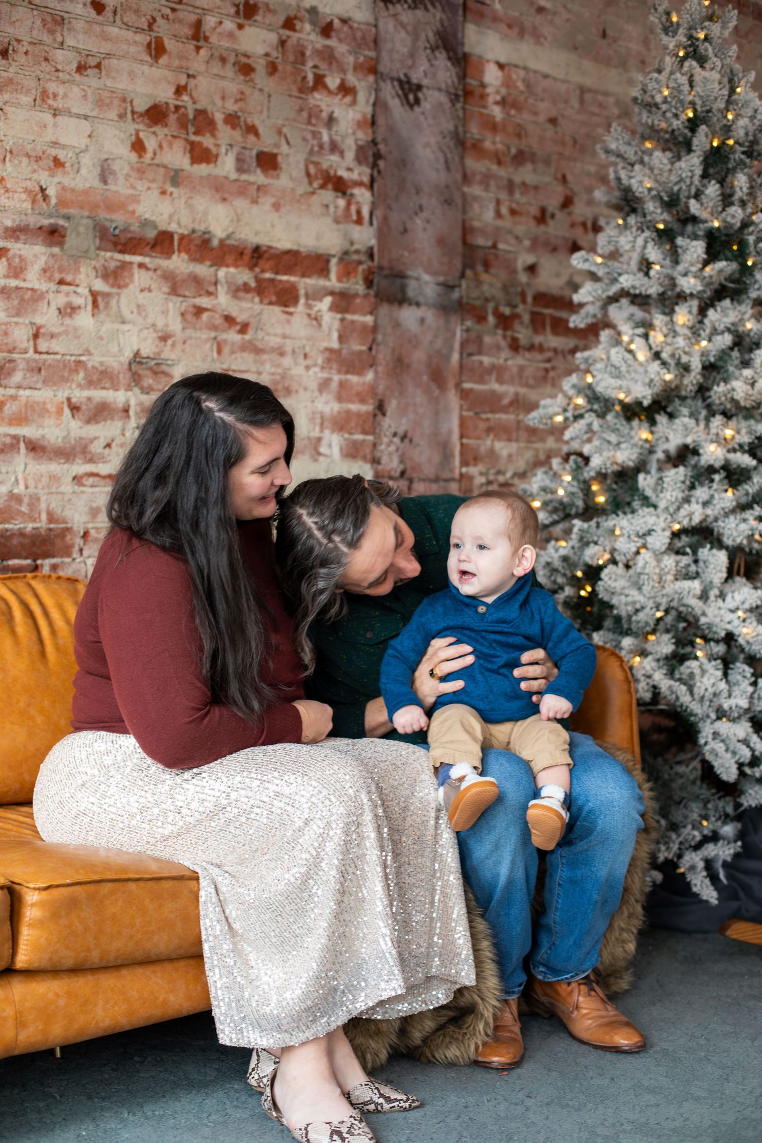 Mom, dad, and baby boy smiling during Cincinnati family photography session, capturing love and joyful family moments.
