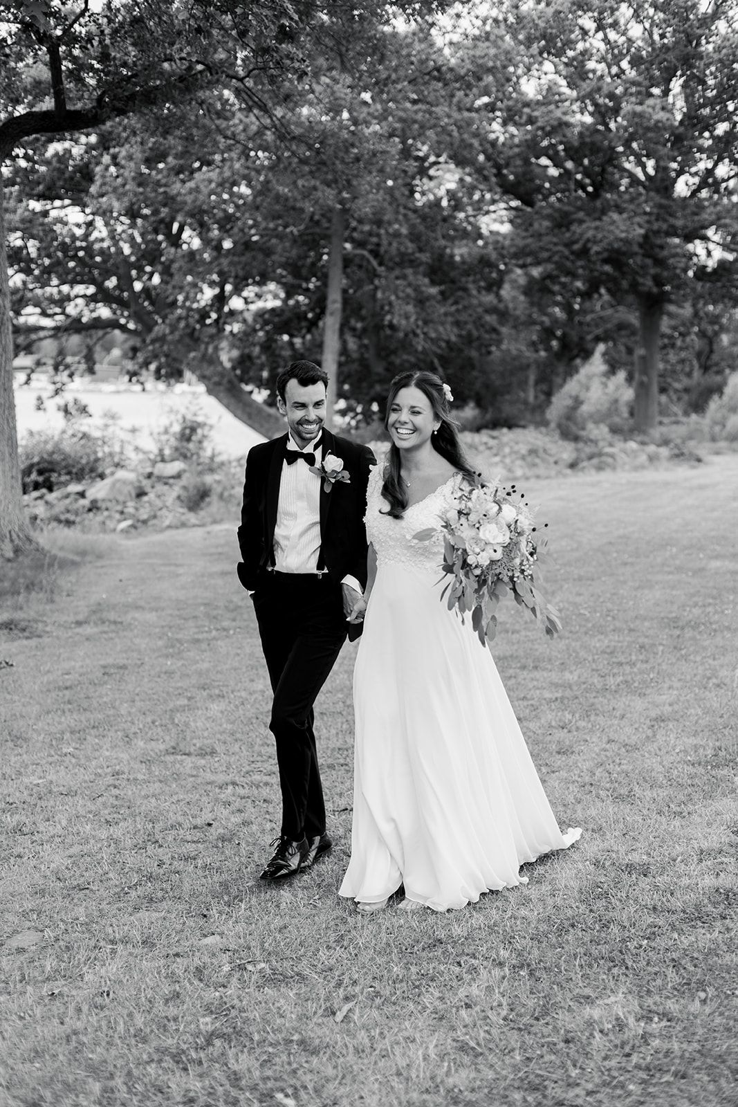 Black and white wedding photo sequence showing a couple dancing together in a grassy outdoor setting.