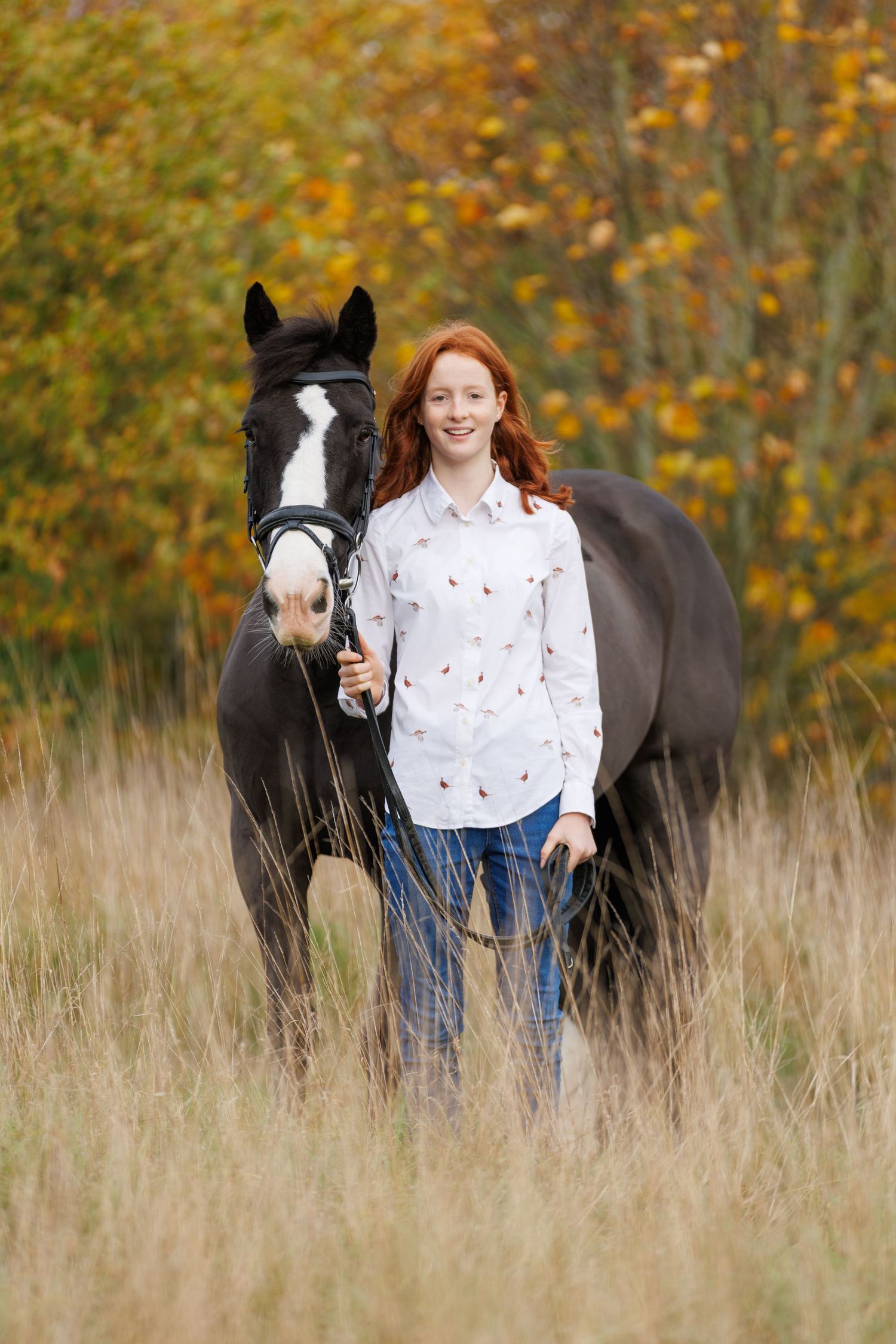A series of photos showing a person in a white polka dot shirt with a black horse in a golden autumn field.