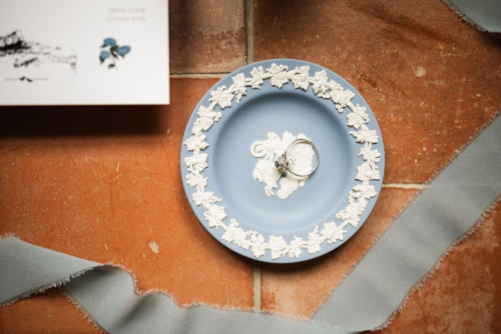 Decorative blue and white porcelain plates displayed in a row on a rustic wooden surface.