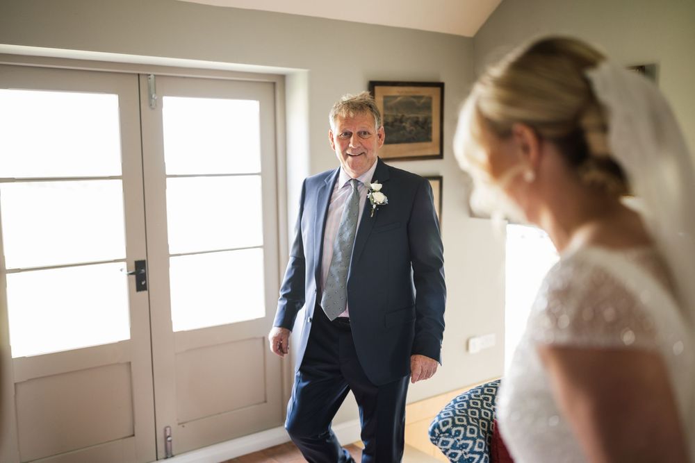 Wedding day preparations in a sunlit room show emotional interactions between loved ones.