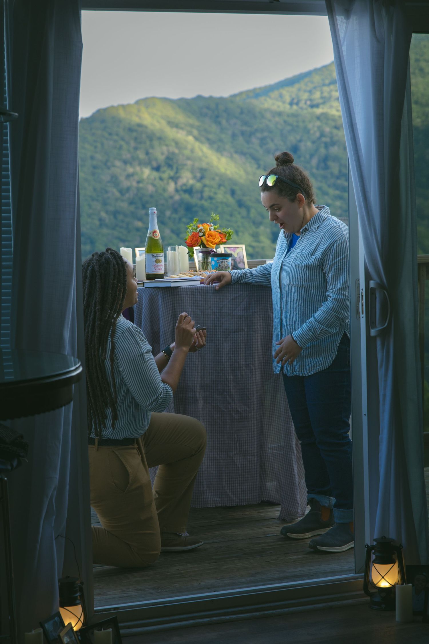 LGBTQ couple holding hands after romantic proposal at blue ridge mountain overlook near Asheville, North Carolina
