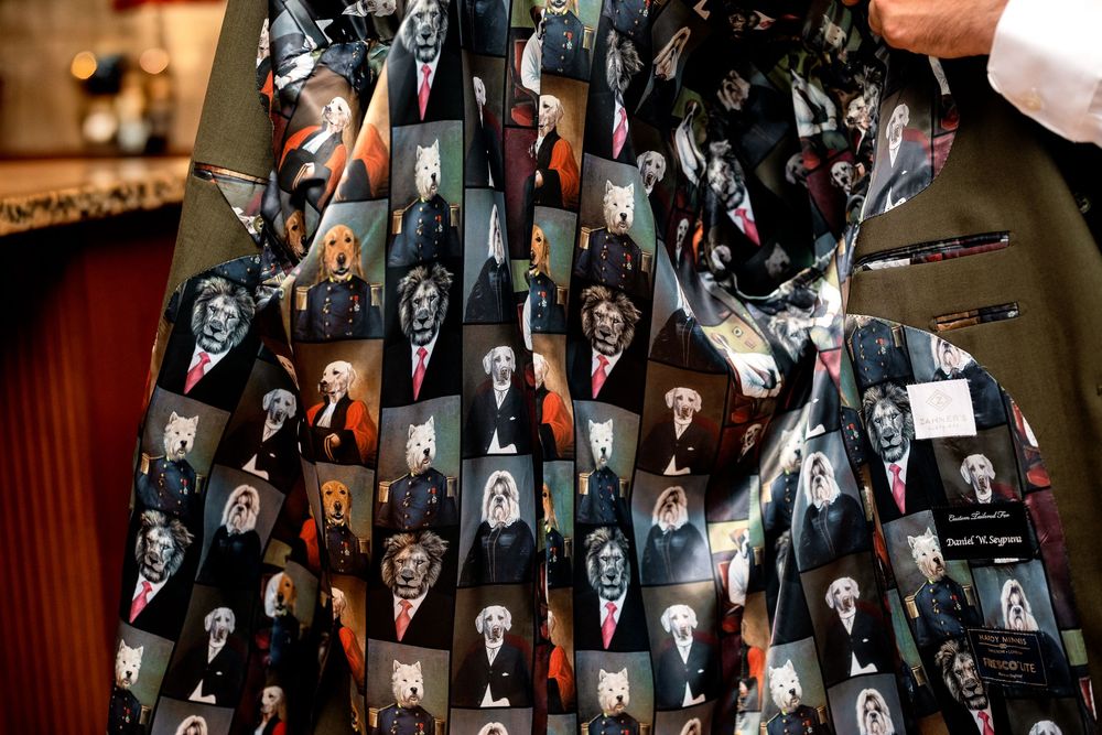 A close-up of fabric with a repeating pattern of black and white horror movie characters and scenes printed on it.