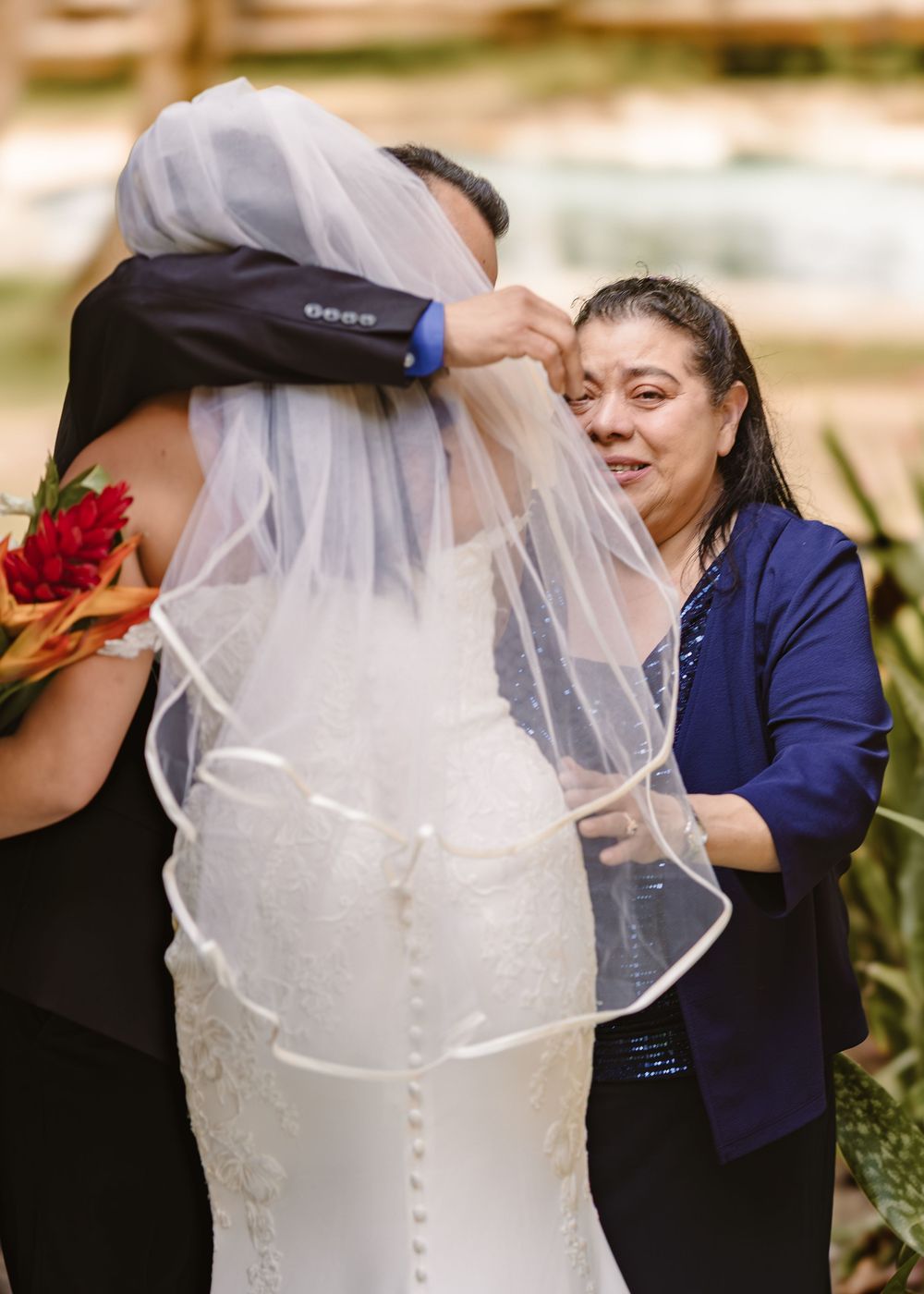 Wedding party preparations show final veil adjustments and joyful moments in a sunlit setting.