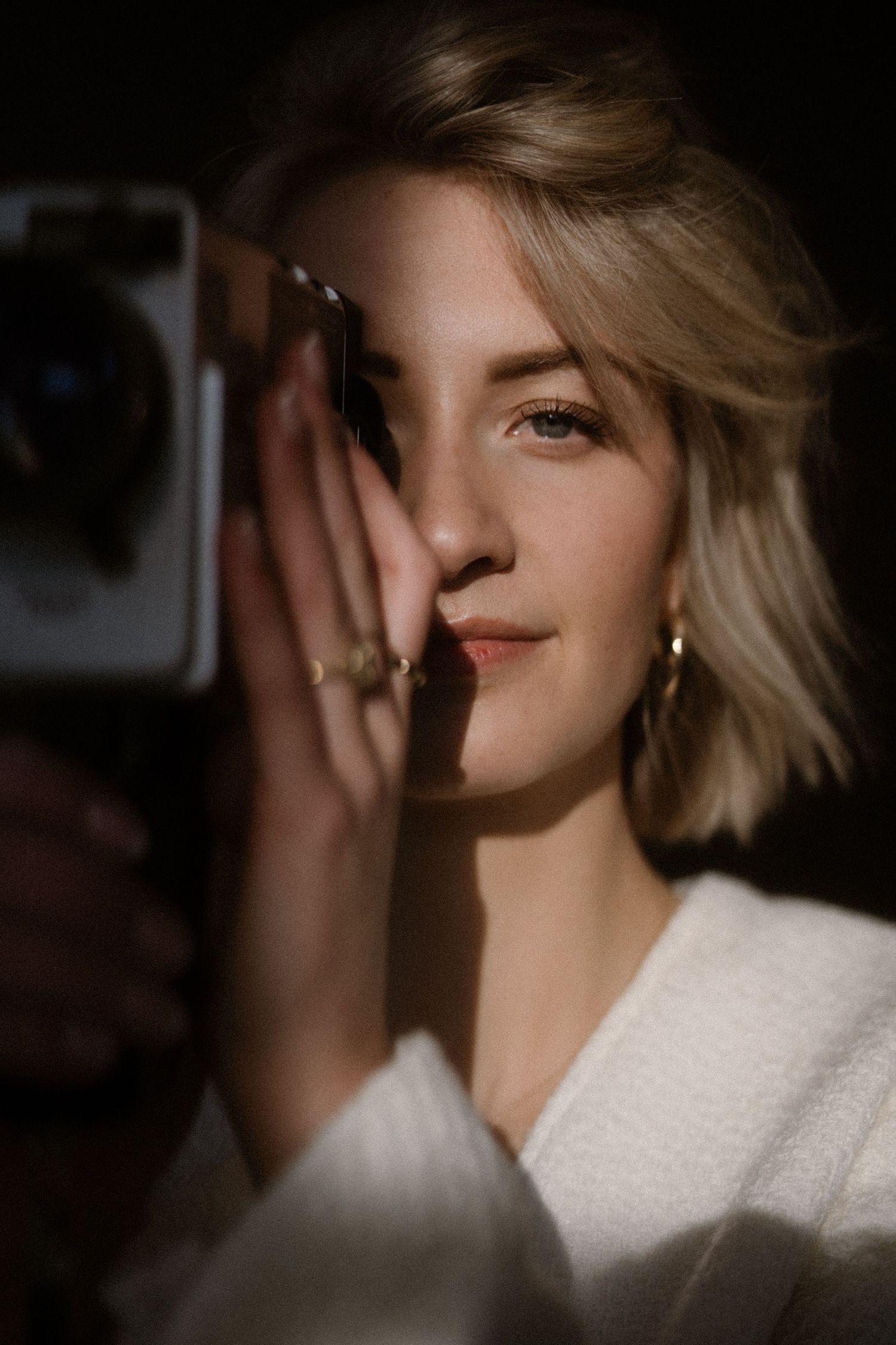 Artistic portrait series with soft lighting and shadows creating a mysterious mood.