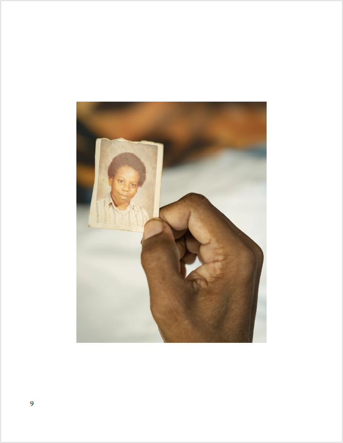 a father holding a picture of his younger self