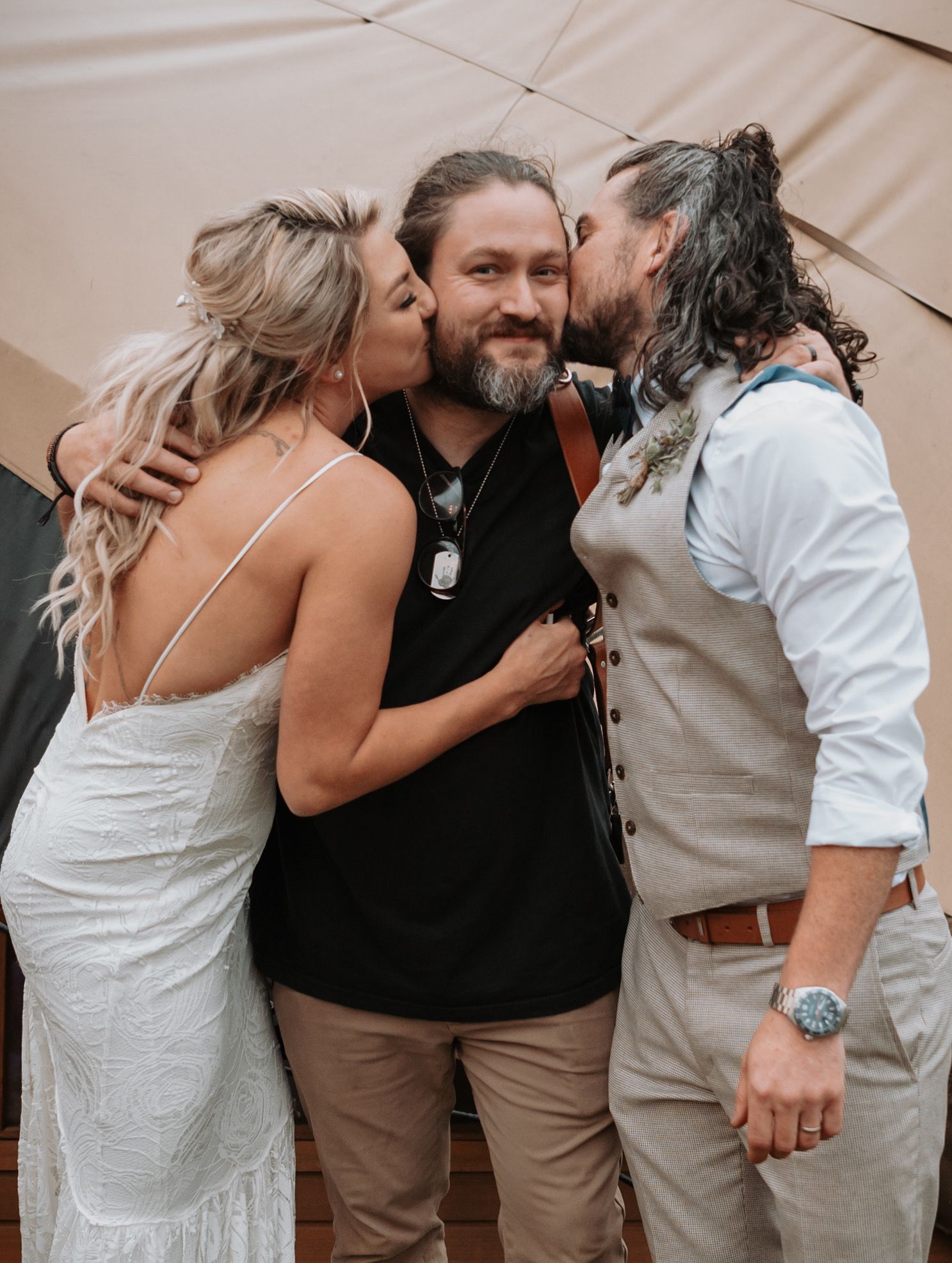 A series of candid emotional moments showing group hugs and embraces at a wedding celebration.