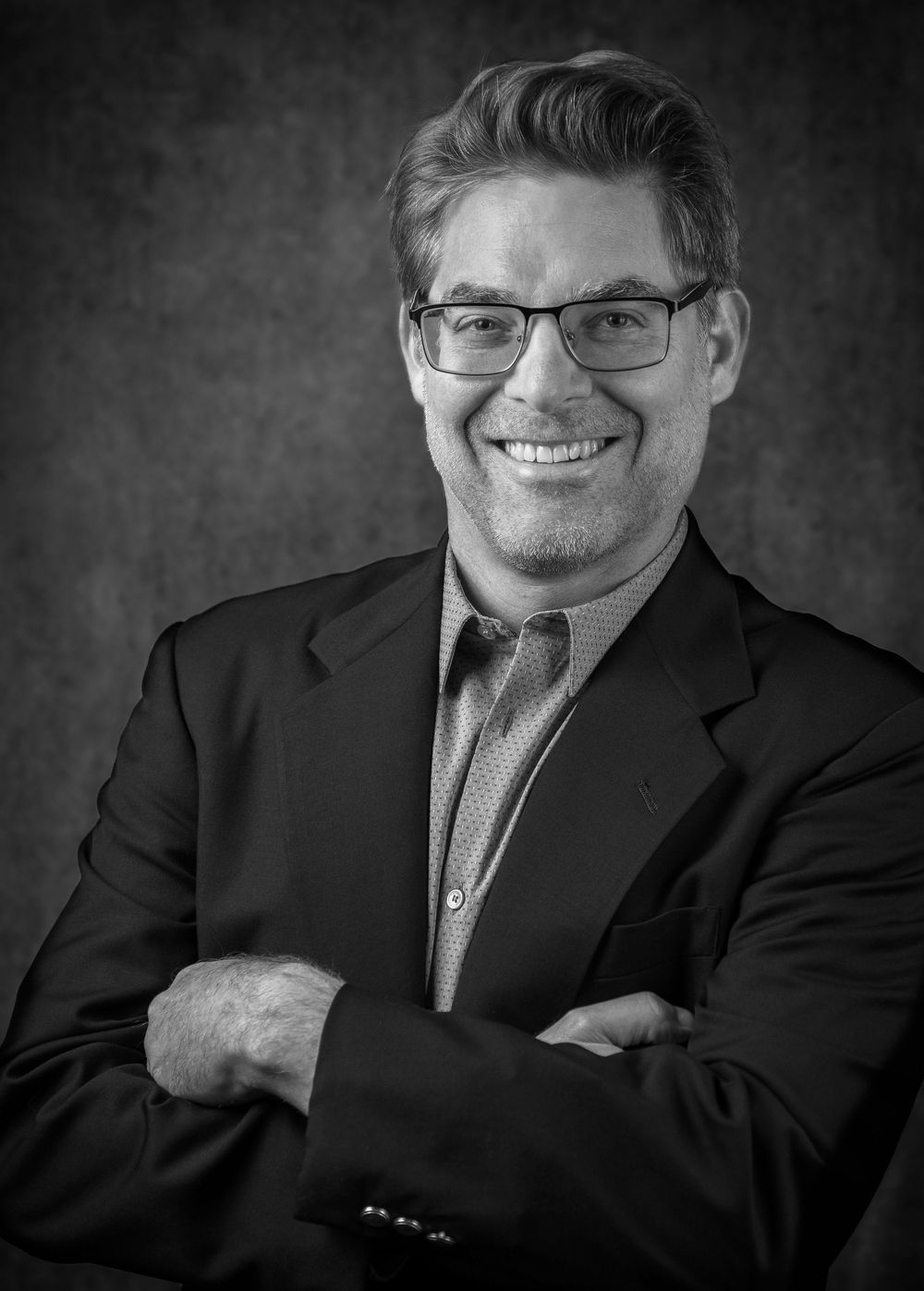 Professional black and white headshot series showing progressive emotions from serious to joyful expressions.