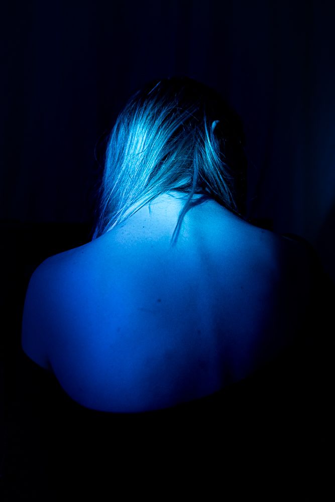 Abstract blue-lit shapes in darkness creating a minimalist artistic composition.