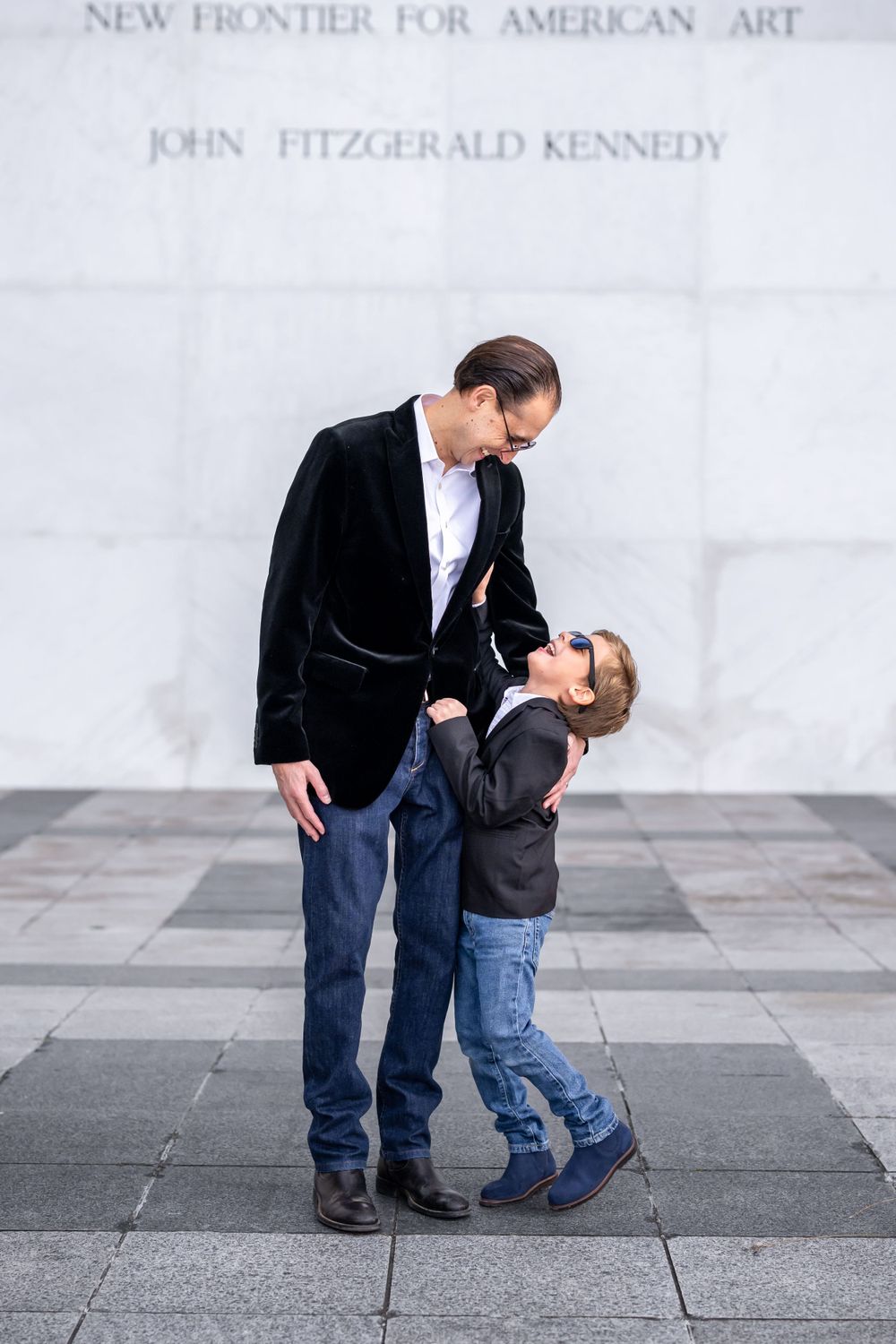 Elegant family photo session at the Kennedy Center in Washington, D.C., featuring stunning indoor chandeliers, panoramic
