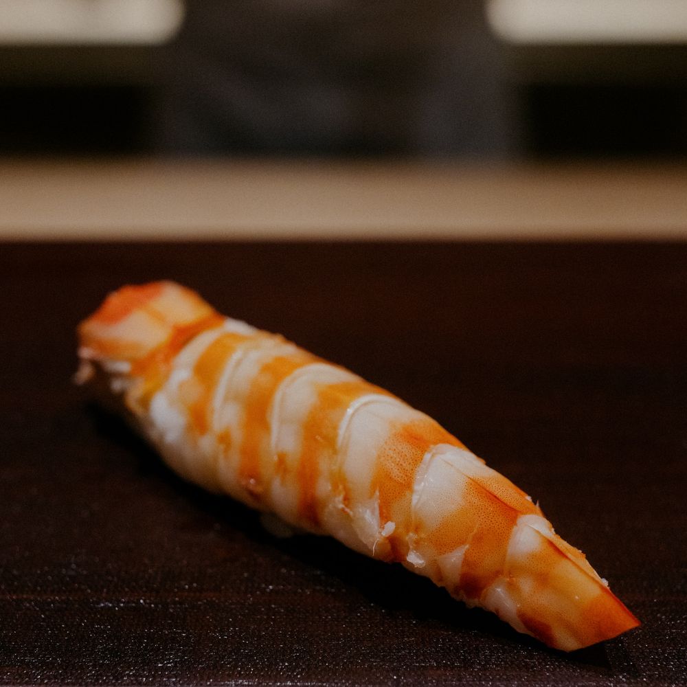 Fresh ebi nigiri sushi with perfectly cooked shrimp displaying classic striped pattern.