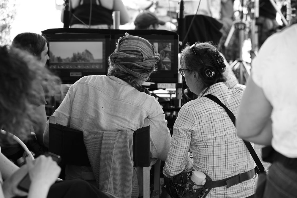 Behind the scenes view of camera operators filming on location.