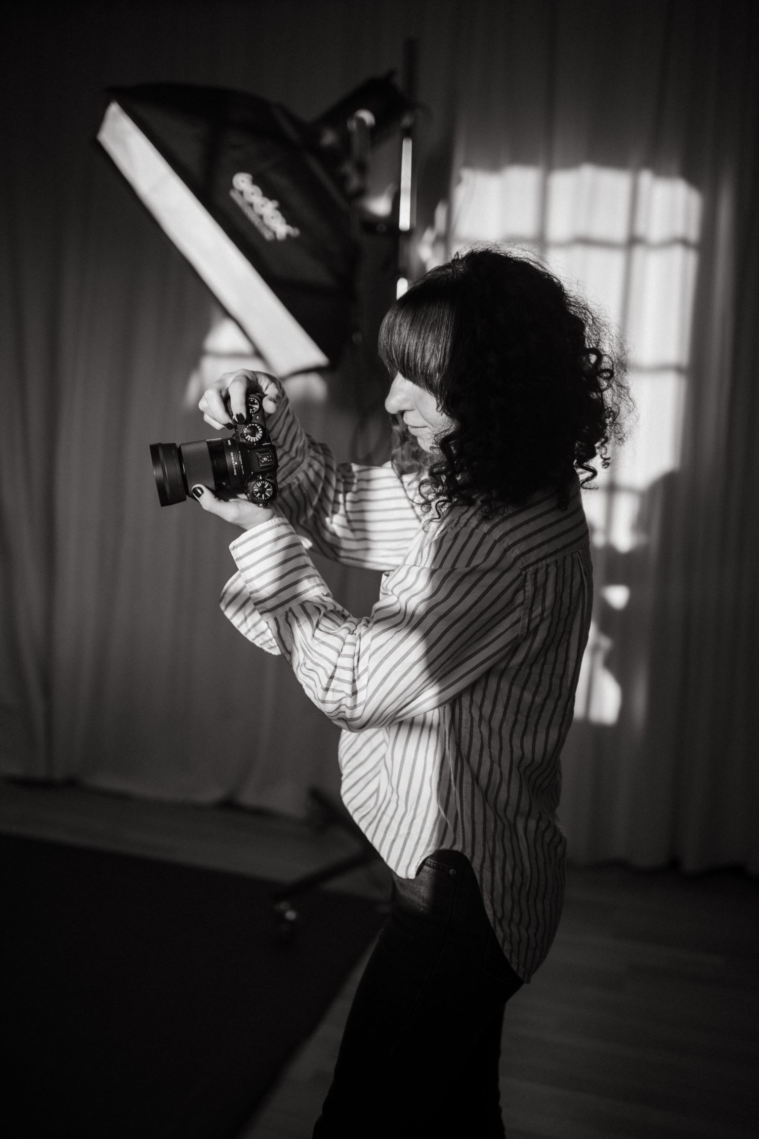event and brand photographer holding camera and shooting in a studio in Stockholm
