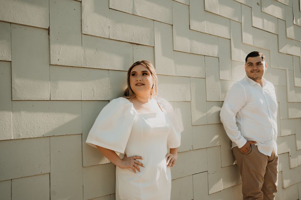 Looking at a textured wall, the couple shares a moment of reflection during their Mazatlán session