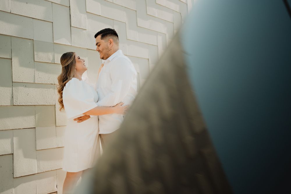 The couple in a romantic embrace, both smiling, showcasing their love in Mazatlán