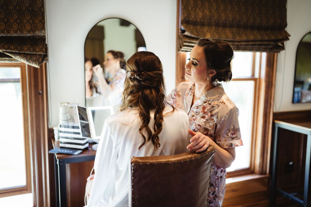 Getting ready scene in room with vintage windows and roman shades.