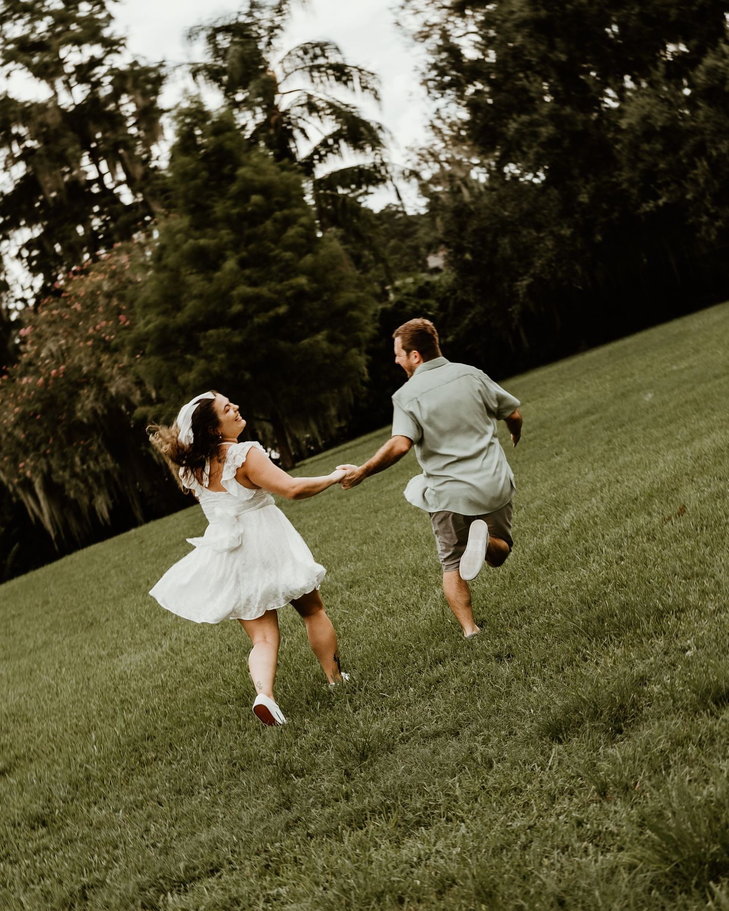 Engagement session video add-on with couple laughing and walking together in Orlando. little white dress. engagement photos. wedding photos