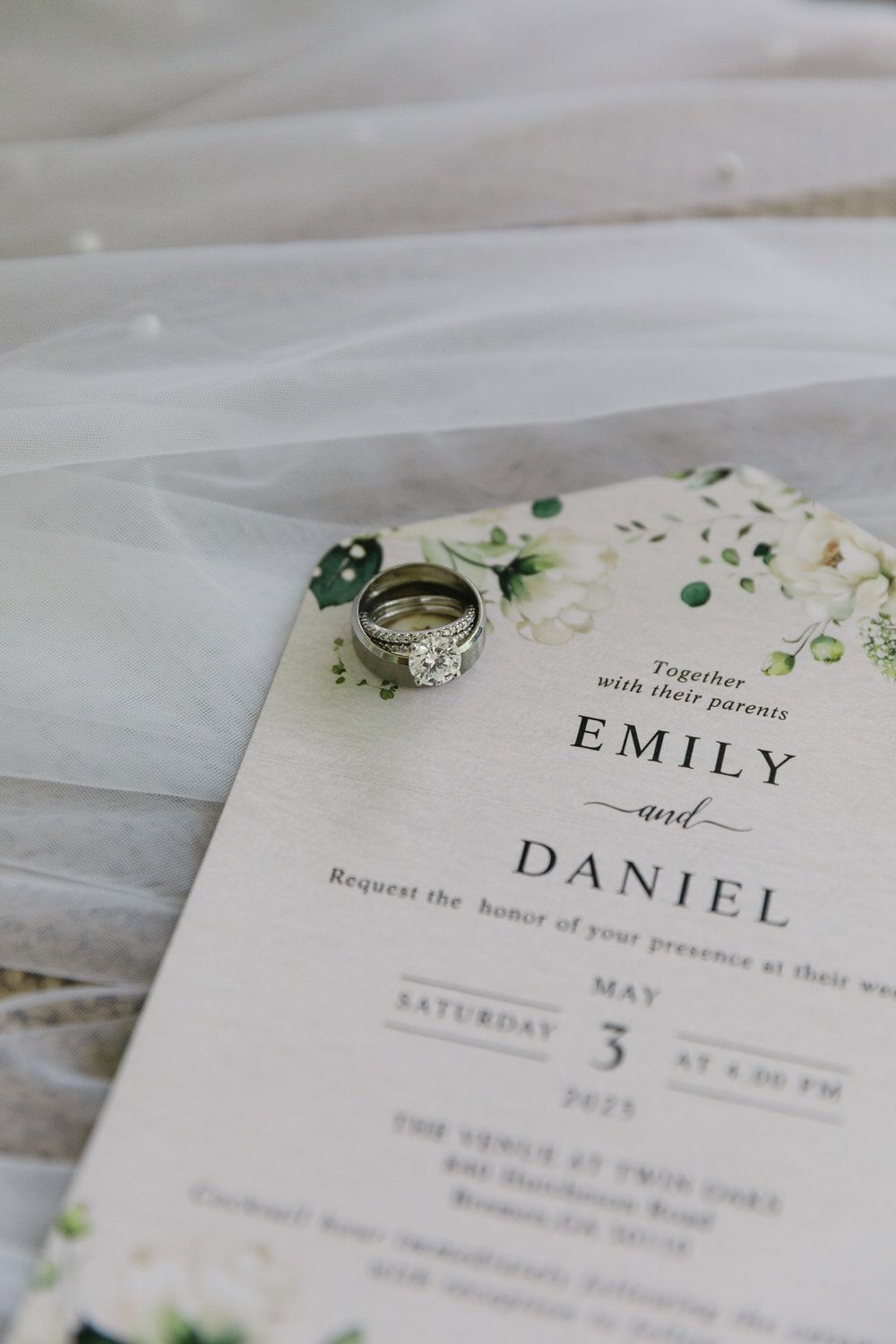 Wedding bands photographed on invitation suite.