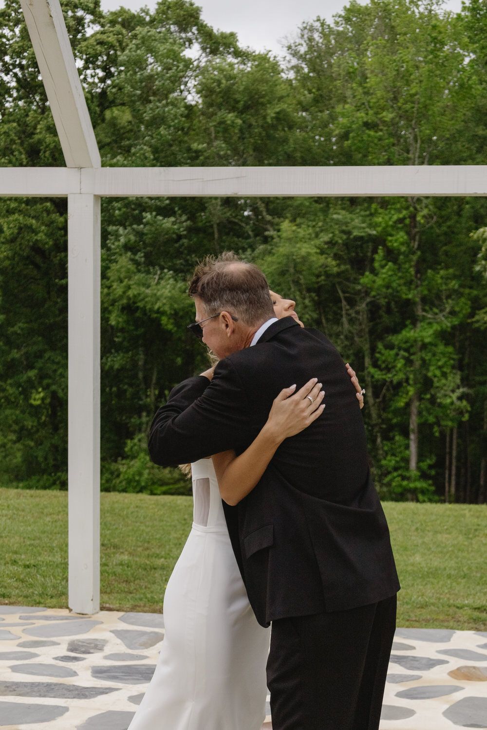 Bride and her dad hugging during their first look on her appalachian wedding day